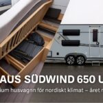 Knaus Südwind 650 UDF Scandinavian Selection med smart förvaring under sängen och stilren exteriör i grått – premium husvagn för året runt-bruk.